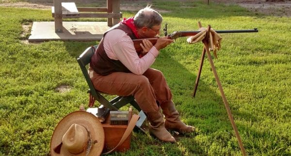 man aiming to shoot targets