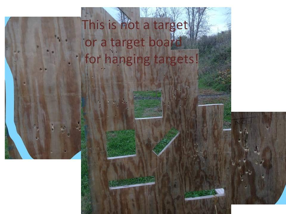 wooden target board with bullet holes