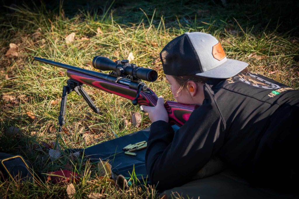 women shooting a pink rifle