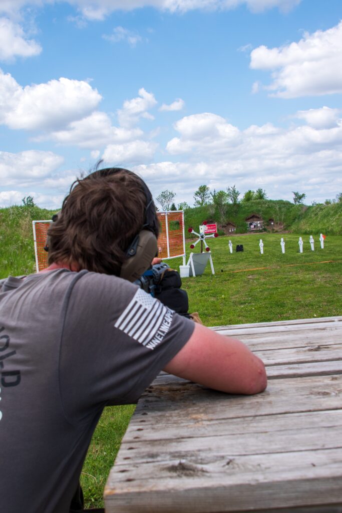 man aiming to shoot target
