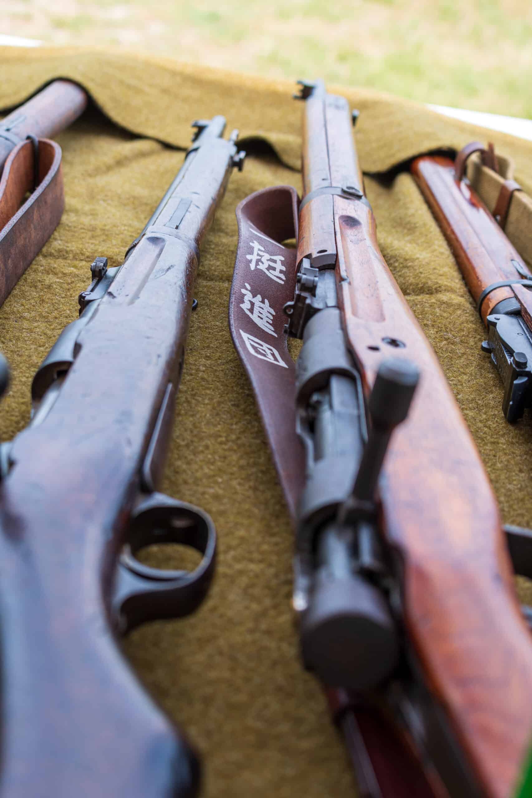 four guns laying on table