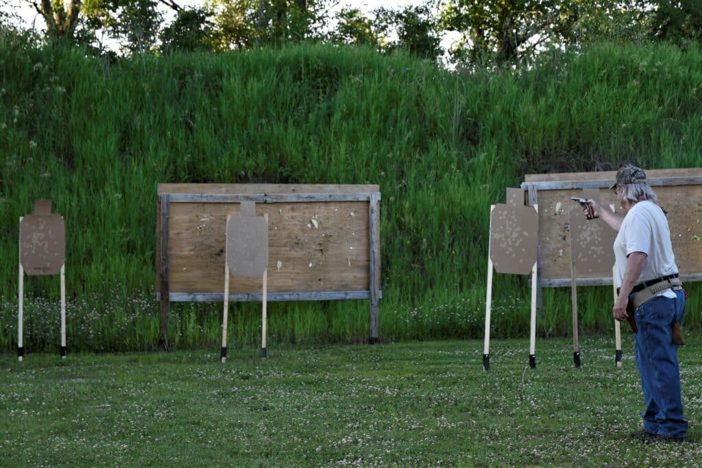 man shooting handgun at target