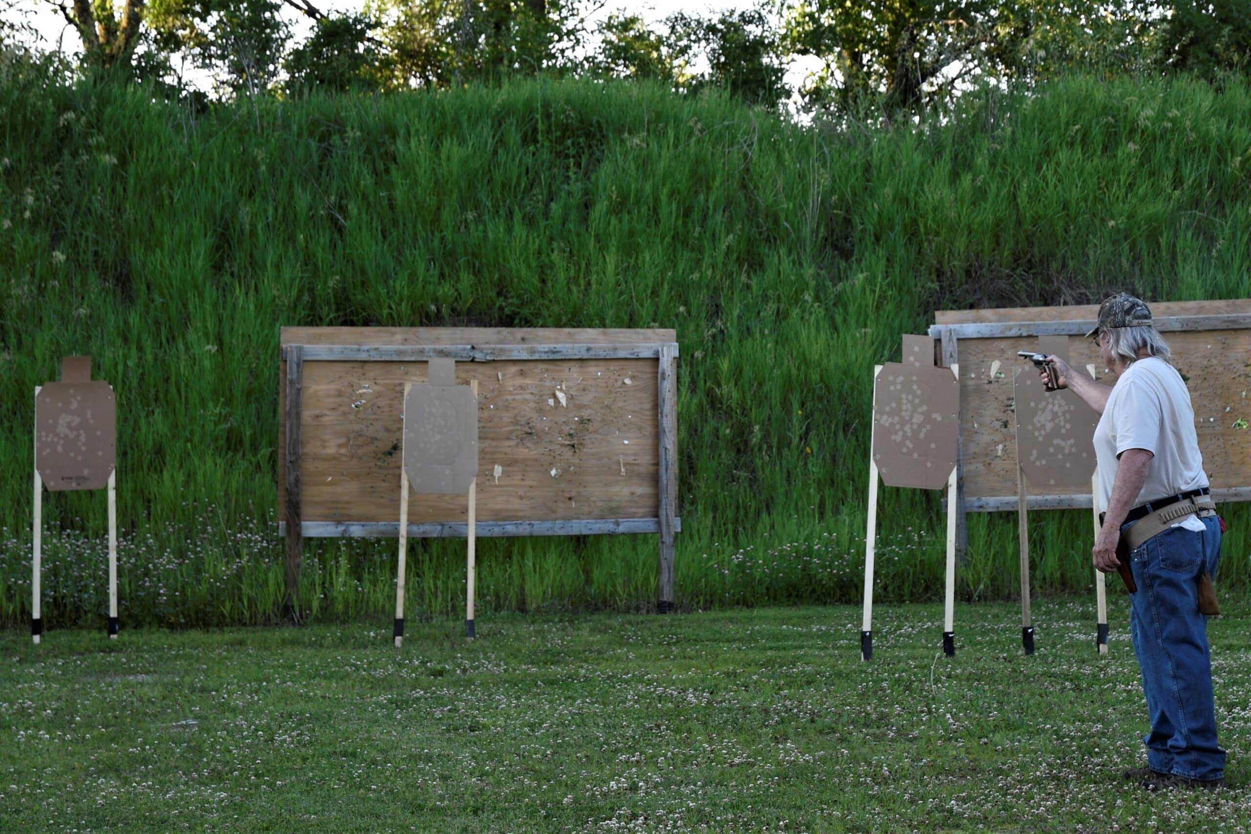 man shooting handgun at target