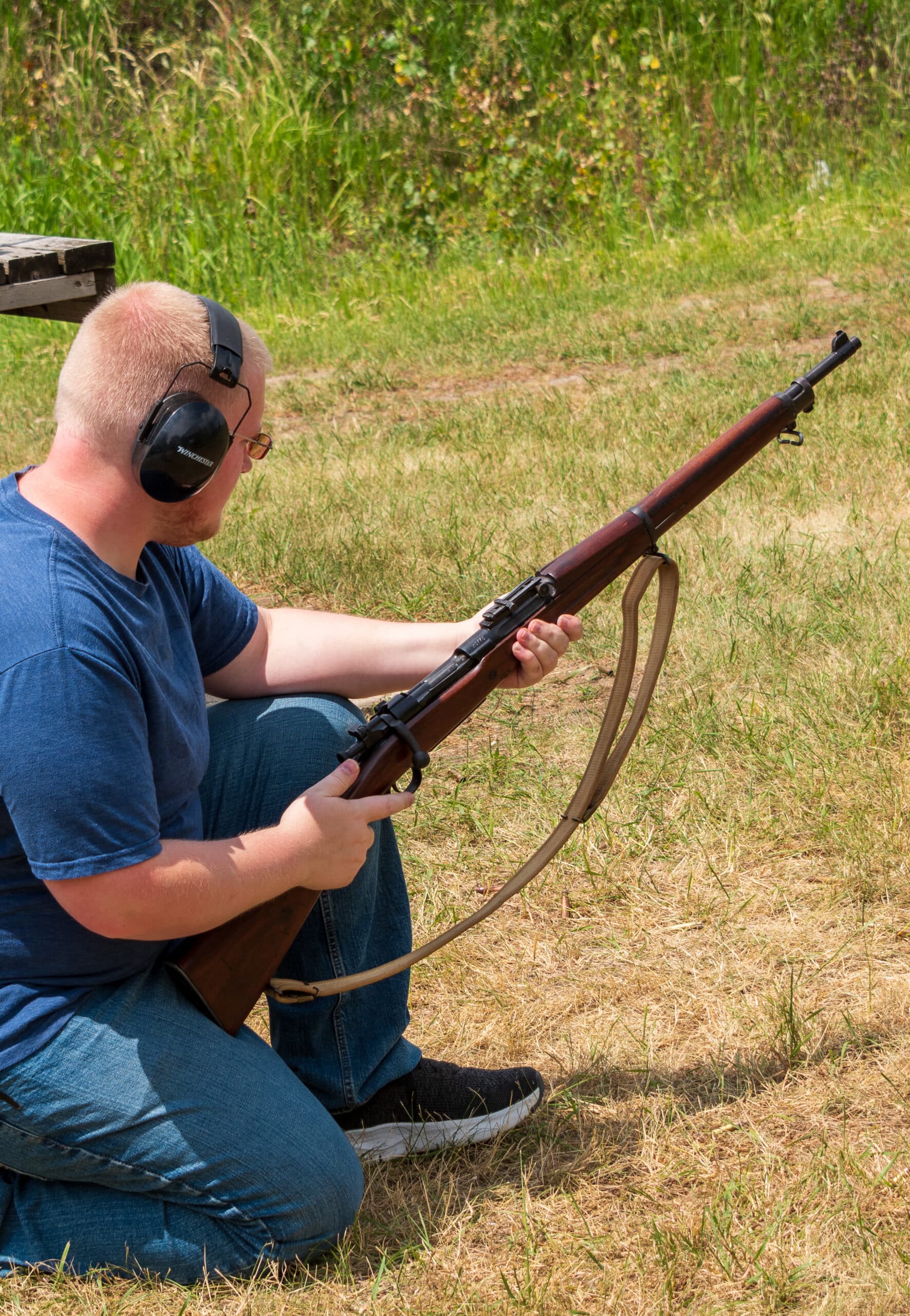 person holding millitary rifle person holding millitary rifle