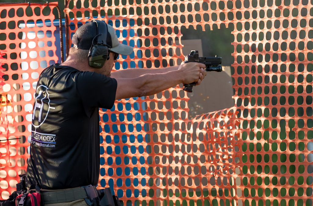 man aiming pistol during defensive pistol league